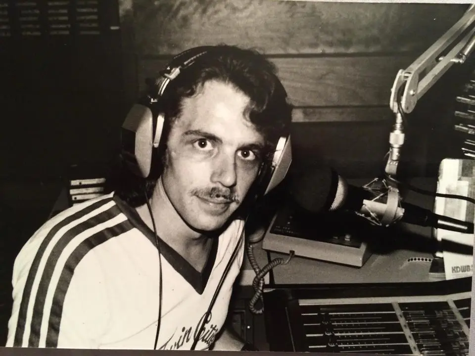 489787664_10163321669124187_8161298329306253518_n A man with headphones on in front of some other people.